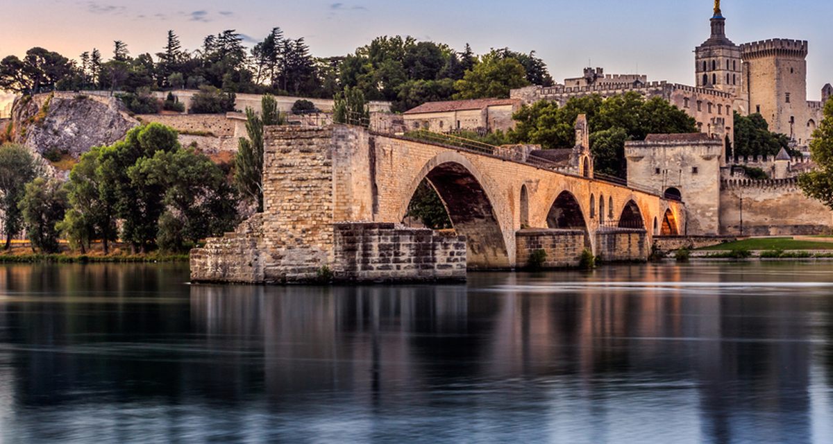 The Pont Saint-Bénézet and Avignon reflected in the Rhône, a highlight of every Rhône river cruise